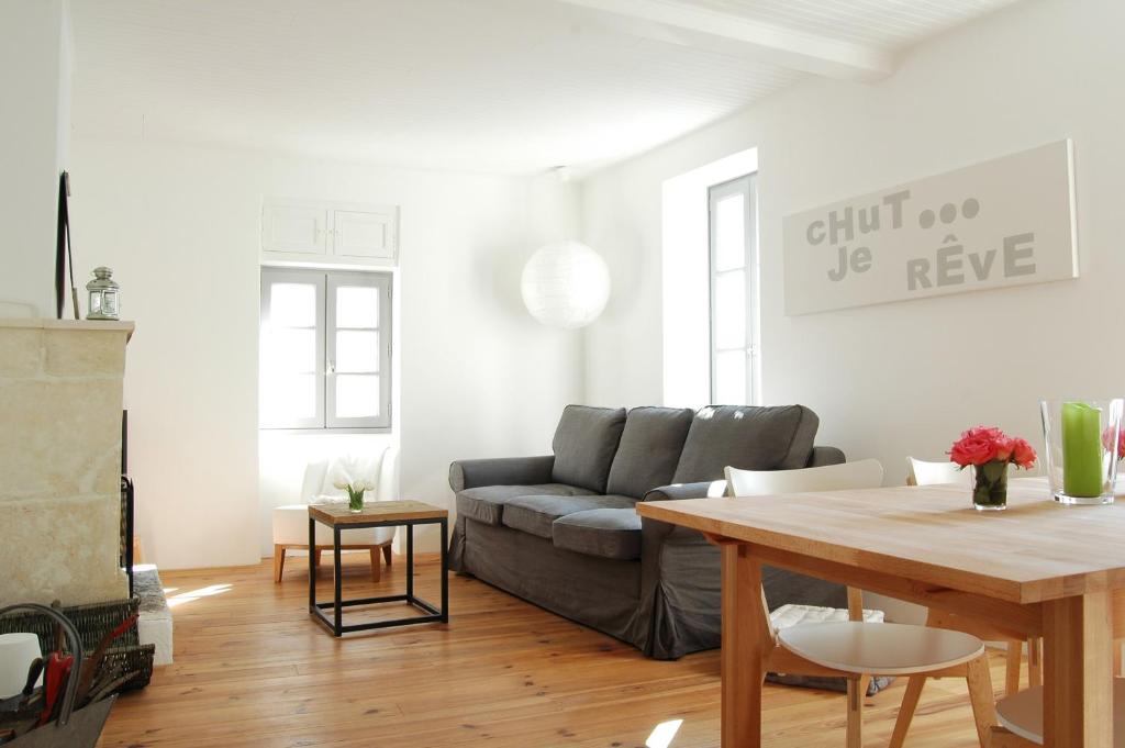 a living room with a couch and a table at 269 Bel Ebat in Le Bois-Plage-en-Ré