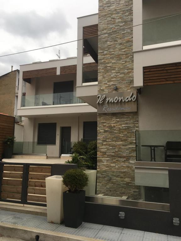 a building with a sign on the side of it at Il Mondo Residence in Stavros