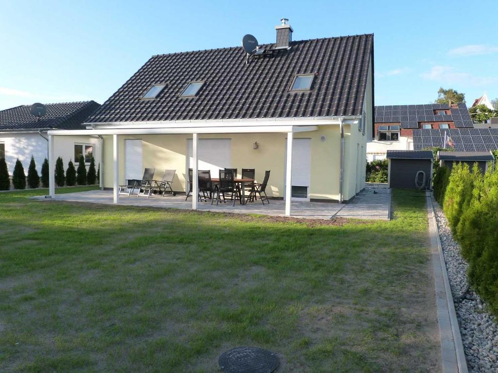 a house with a patio and a roof at FH Moewenkoje_SCHU in Ostseebad Karlshagen