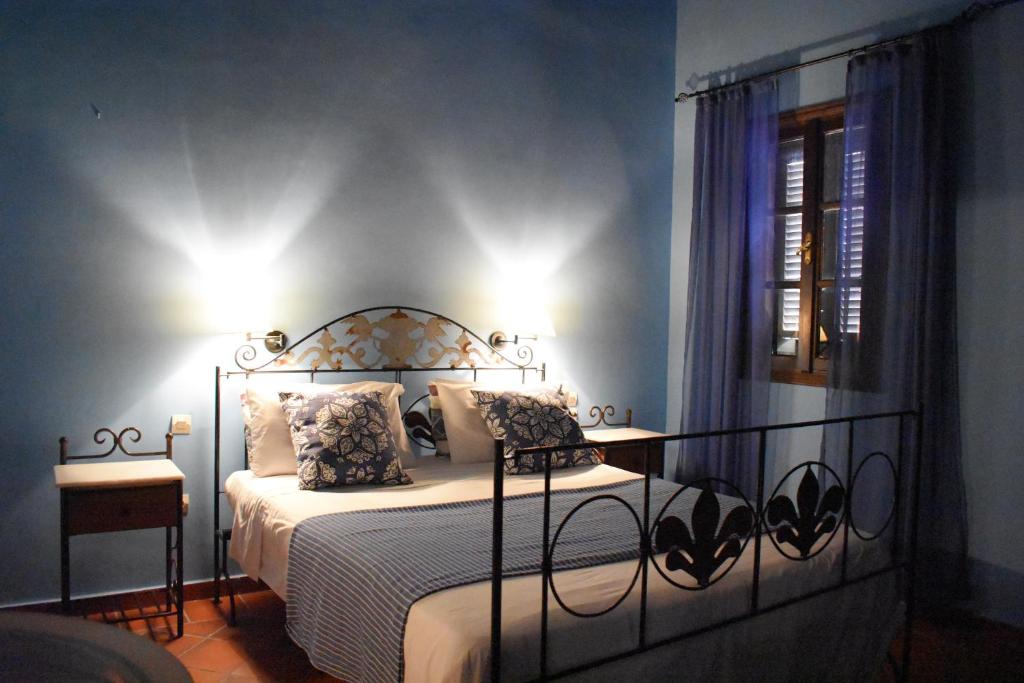 a bedroom with a bed with a wrought iron headboard at Antifanous Apartments in Rhodes Town