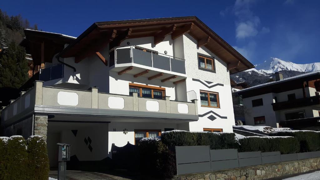 a white building with a balcony on top of it at Haus Remler in Matrei in Osttirol