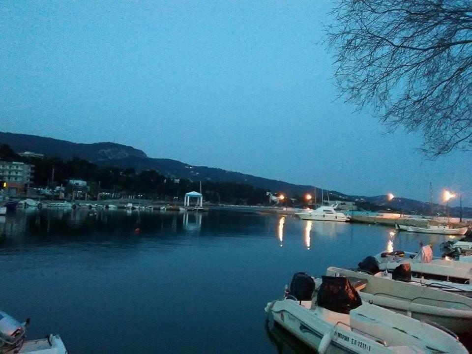 a harbor with boats in the water at night at Orizontes Suites A in Kalamos