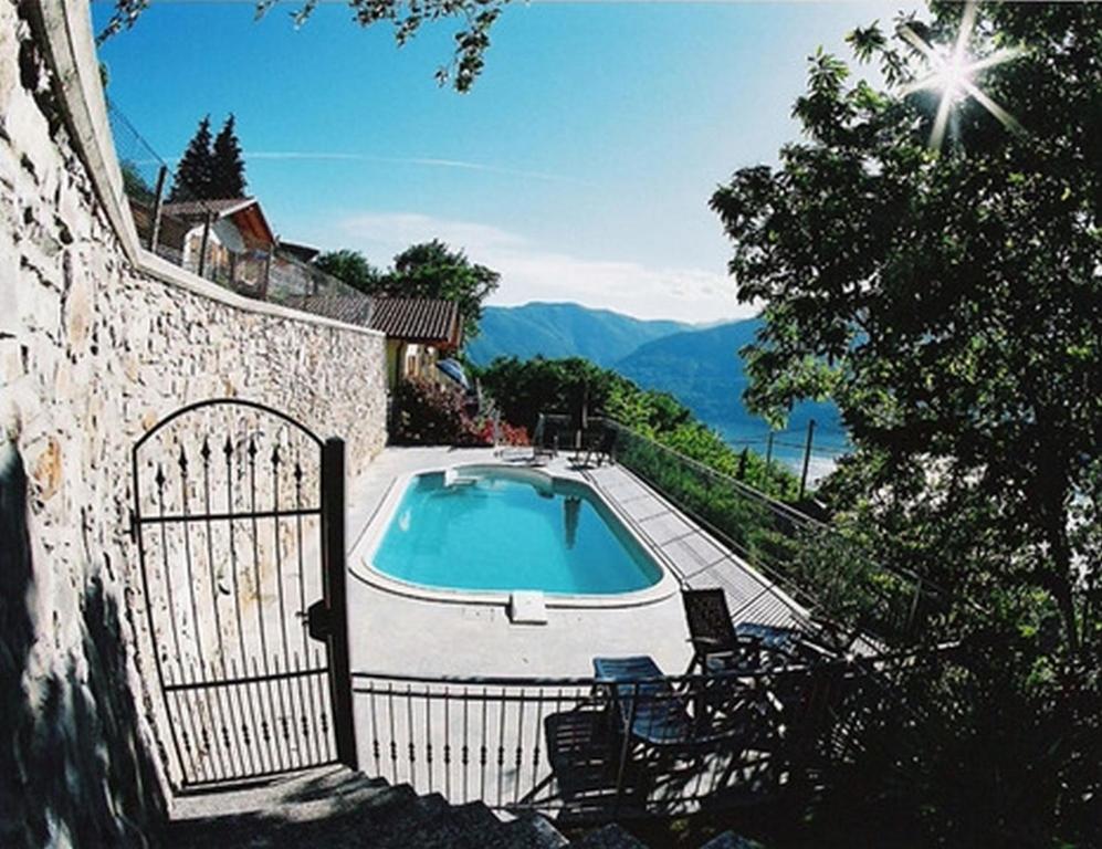 a villa with a swimming pool and a fence at Case Bellissime in Tronzano Lago Maggiore