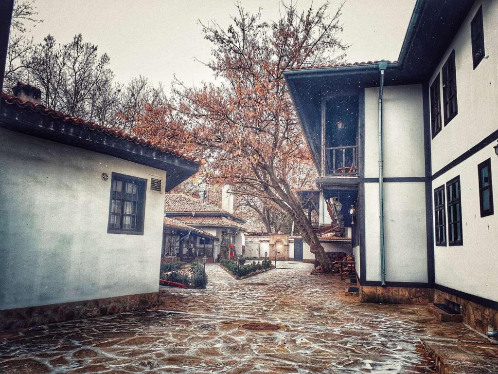 a cobblestone street in front of two buildings at Khan Staria Dobrich Family Hotel in Dobrich