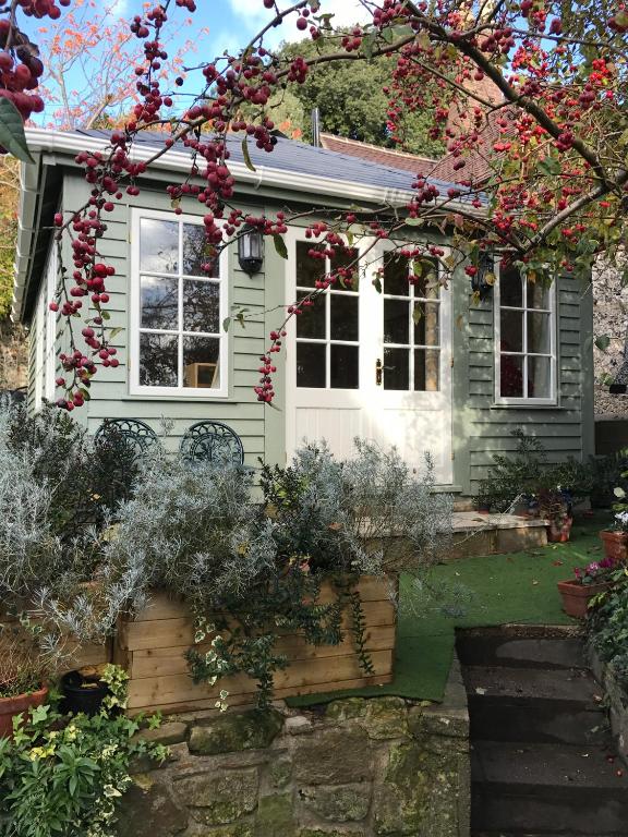 a small house with a garden in front of it at Crabapple Cottage B&B in Lewes
