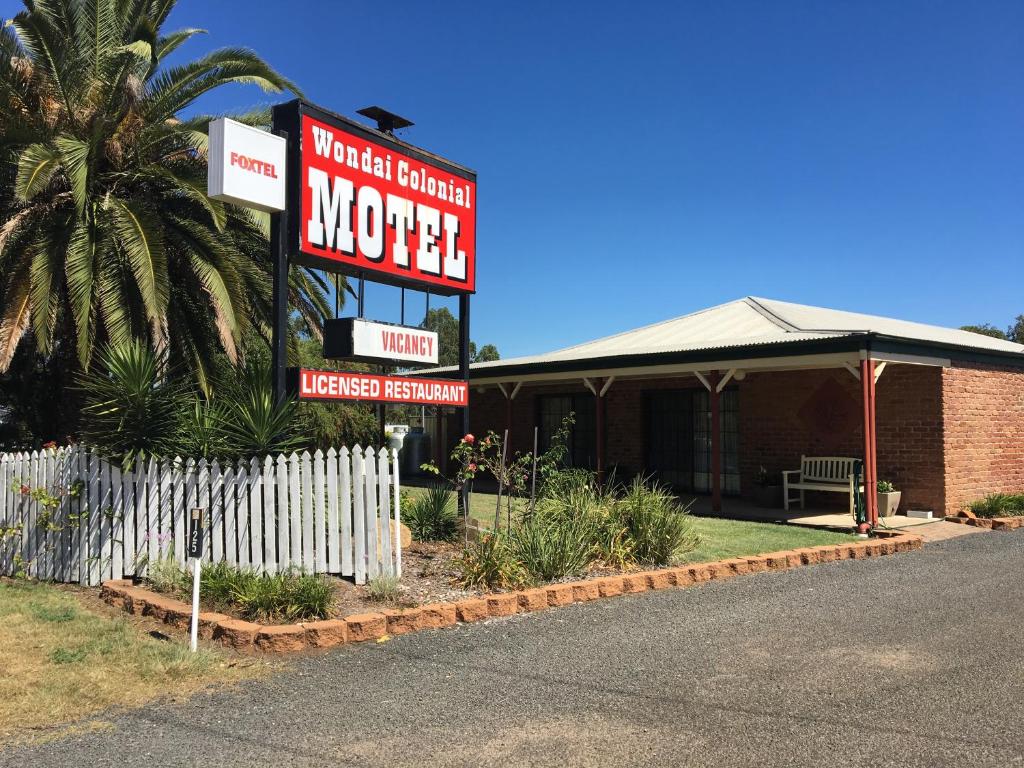 a motel sign in front of a building at Wondai Colonial Motel in Wondai