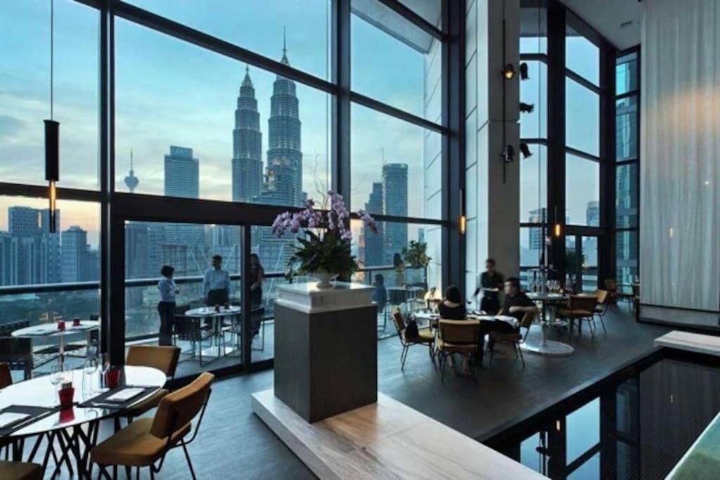 a restaurant with a view of the city at Exclusive The Troika Luxury Apartment in Kuala Lumpur