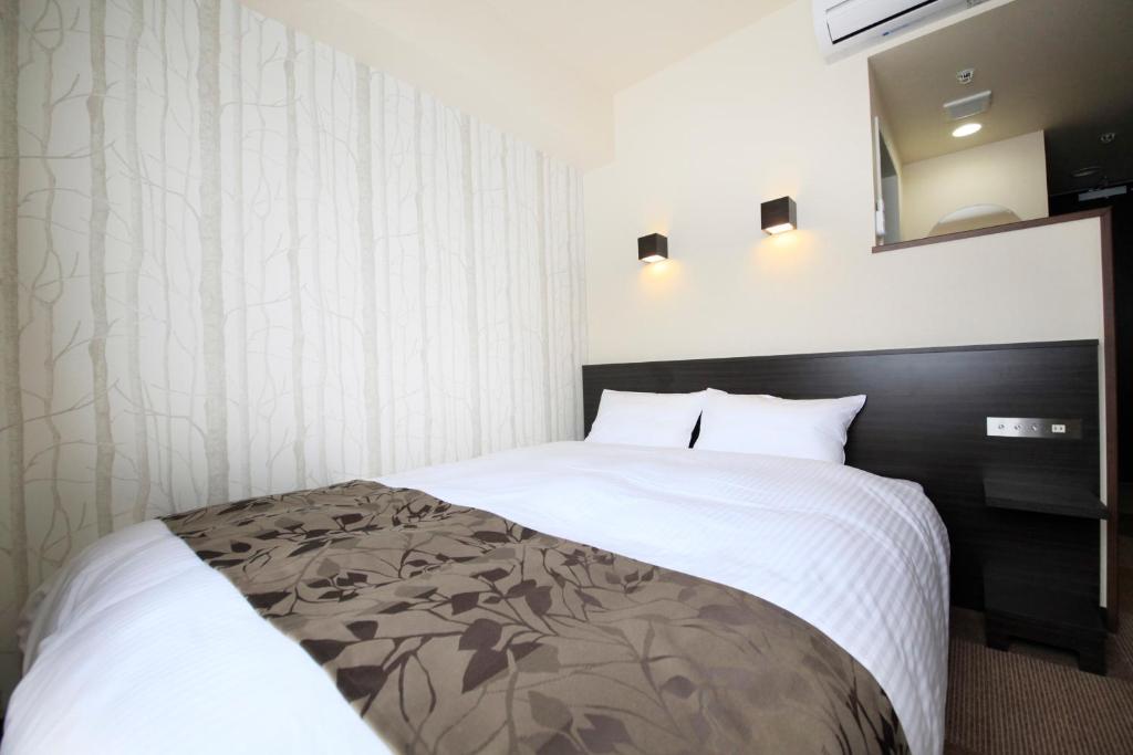 Postel nebo postele na pokoji v ubytování Hotel Lifetree Hitachinoushiku