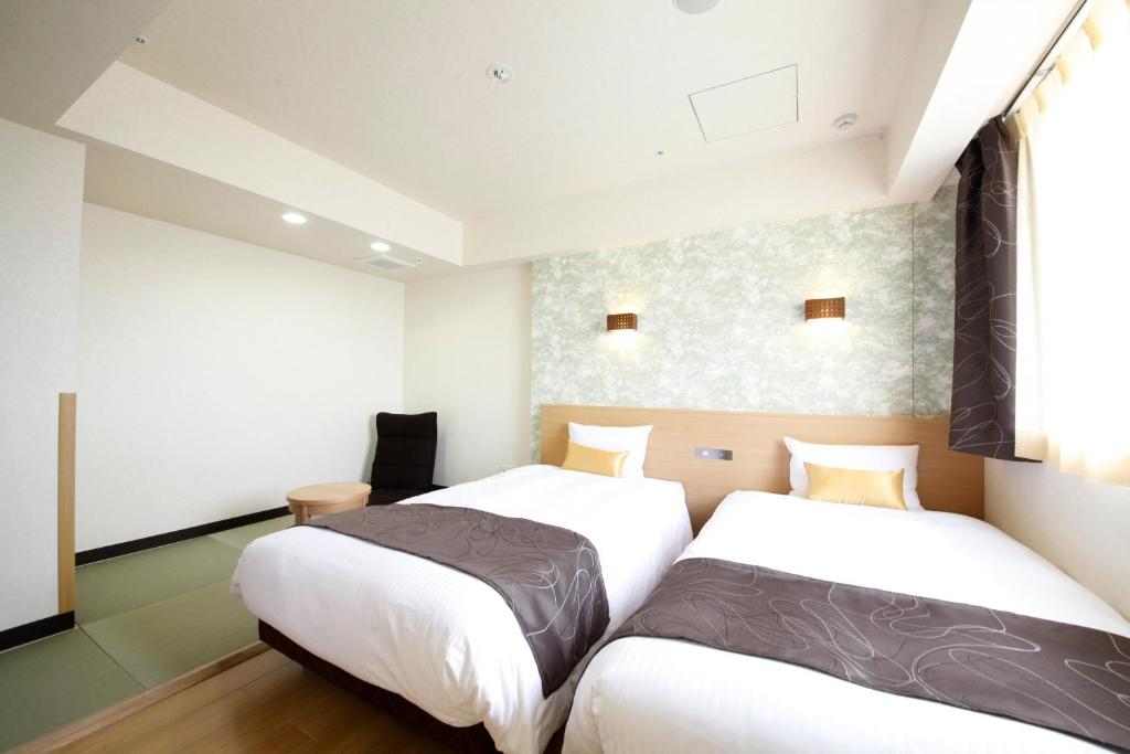 Postel nebo postele na pokoji v ubytování Hotel Lifetree Hitachinoushiku