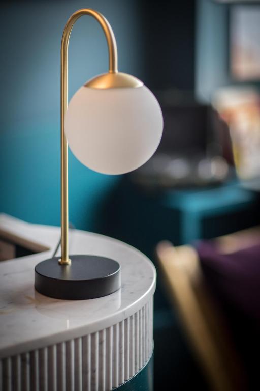 a lamp sitting on top of a table at ibis Styles Paris Nation Cours de Vincennes in Paris