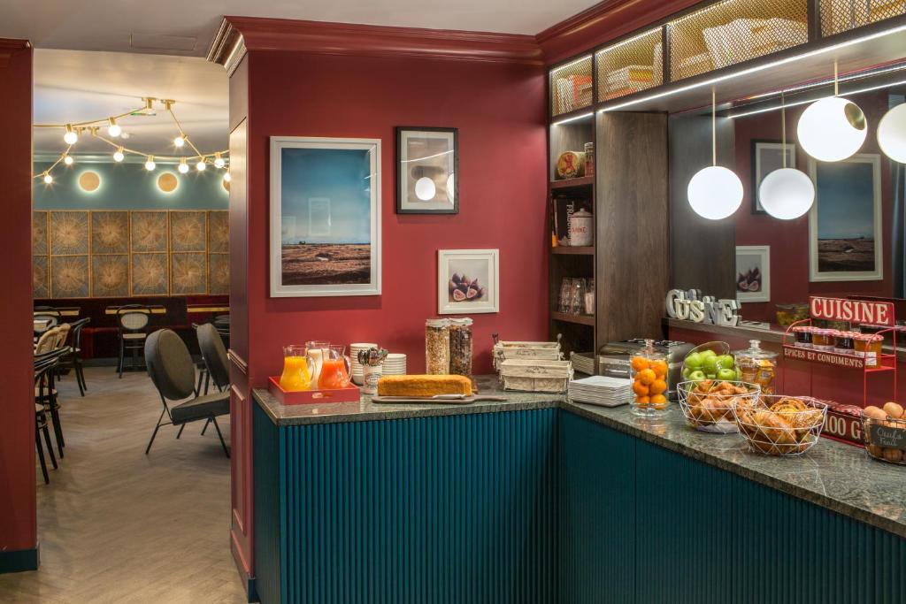 a restaurant with a counter with food on it at ibis Styles Paris Nation Cours de Vincennes in Paris