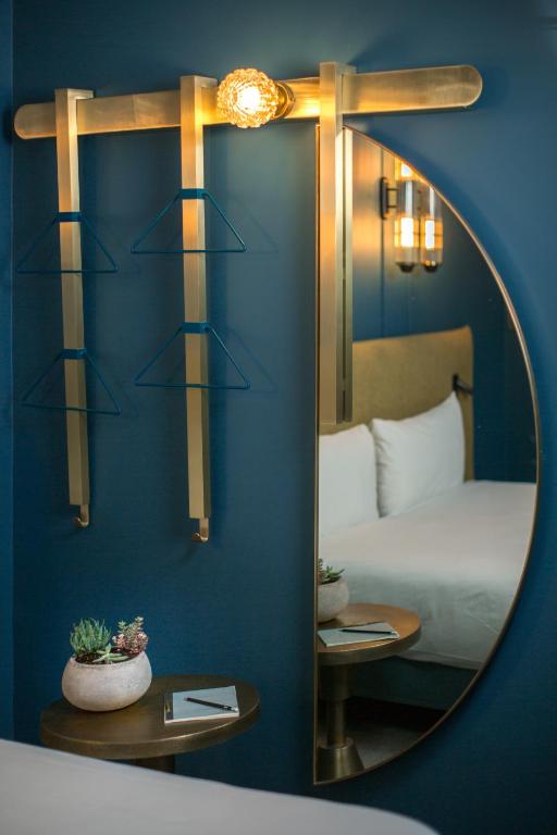a mirror in front of a bedroom with a bed at ibis Styles Paris Nation Cours de Vincennes in Paris