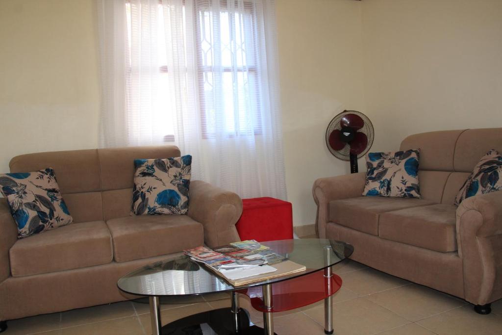 a living room with a couch and a table at Wemofa Pad Self-Catering Apartment in Entebbe