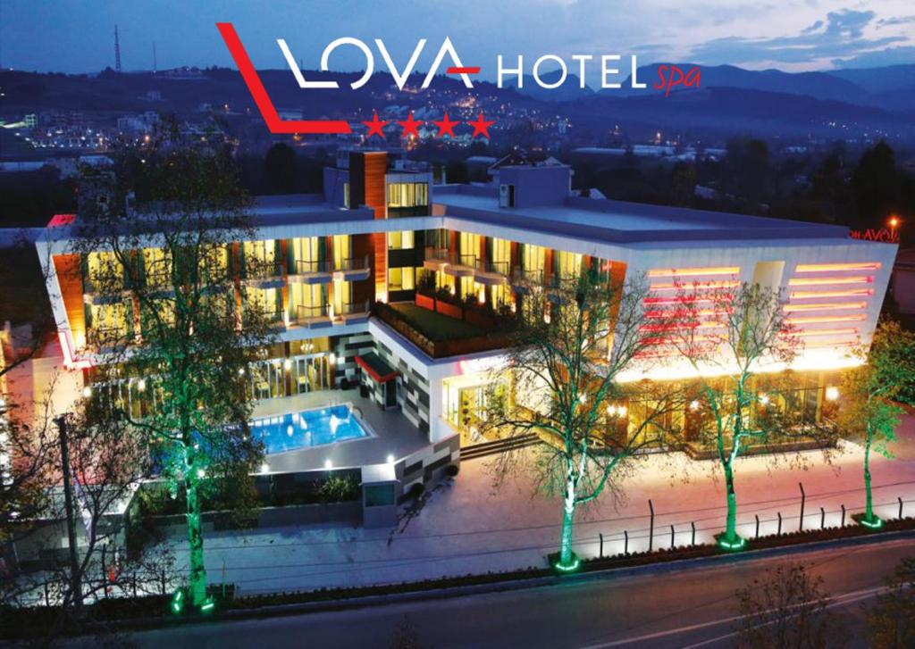 a hotel with a pool in front of a building at Yalova Lova Hotel & SPA Yalova in Yalova