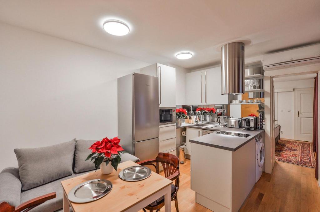 a kitchen and living room with a couch and a table at Romantic Apartment Prague near Charles Bridge in Prague