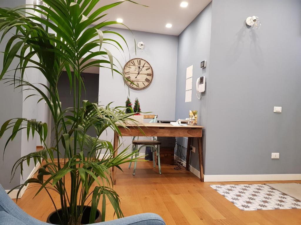 an office with a desk and a clock on the wall at La Terrazza di Carolina in Agrigento