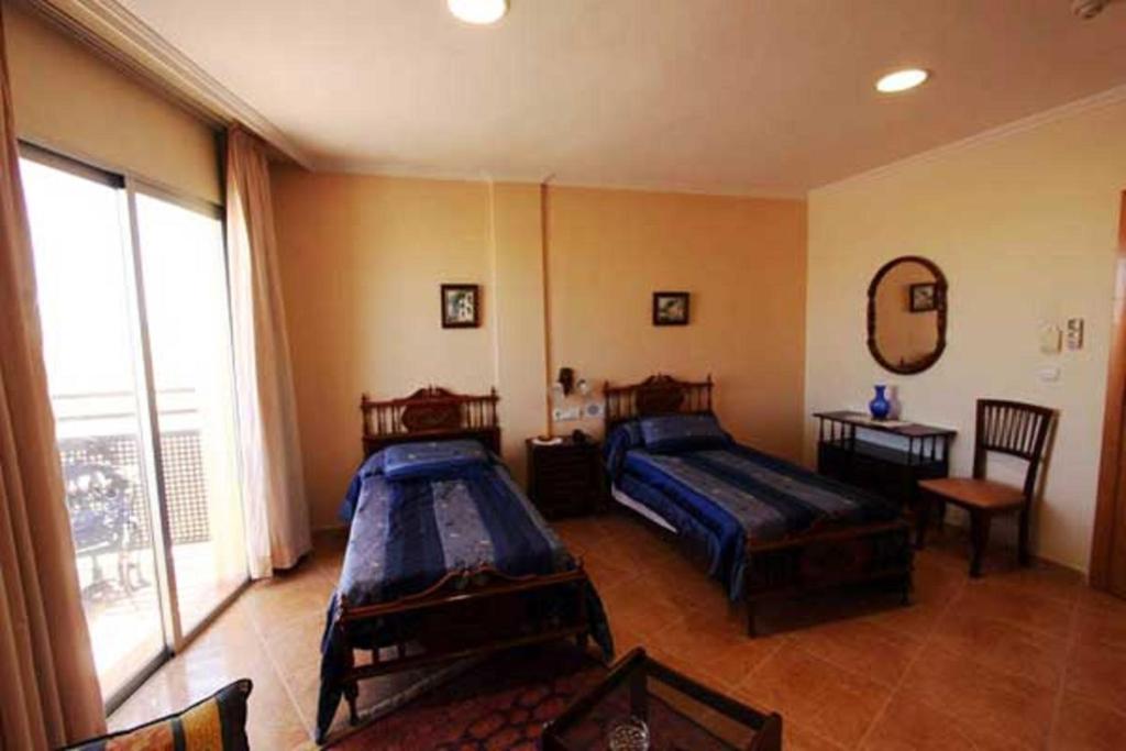 Postel nebo postele na pokoji v ubytování Hotel Paloma