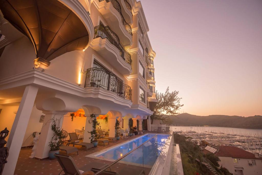 a large building with a swimming pool in front of it at Casa Margot Hotel - Adults Only in Fethiye