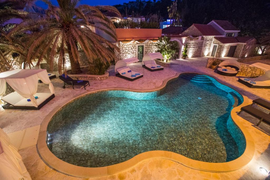 an overhead view of a swimming pool at night at Villa Diamond in Mlini
