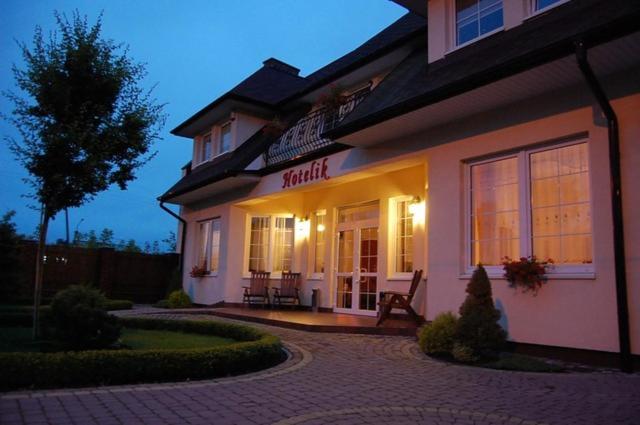 a building with a sign that says market on it at Hotelik - Modlin Airport in Nowy Dwór Mazowiecki