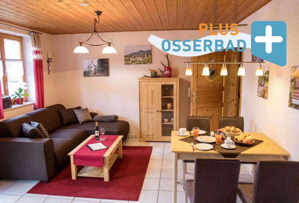 a living room with a couch and a table at Ferienwohnung "Woidliebe" in Lohberg