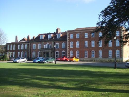a large brick building with cars parked in front of it at The Bannatyne Spa Hotel in Hastings