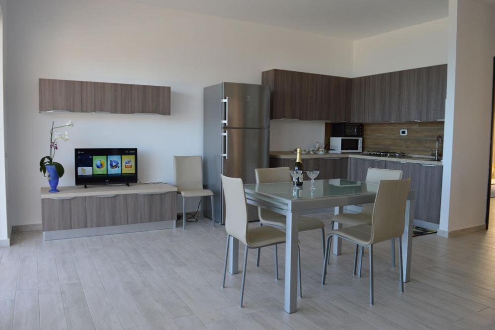 a kitchen and dining room with a table and chairs at Appartamenti Sole a Zambrone Village in Zambrone