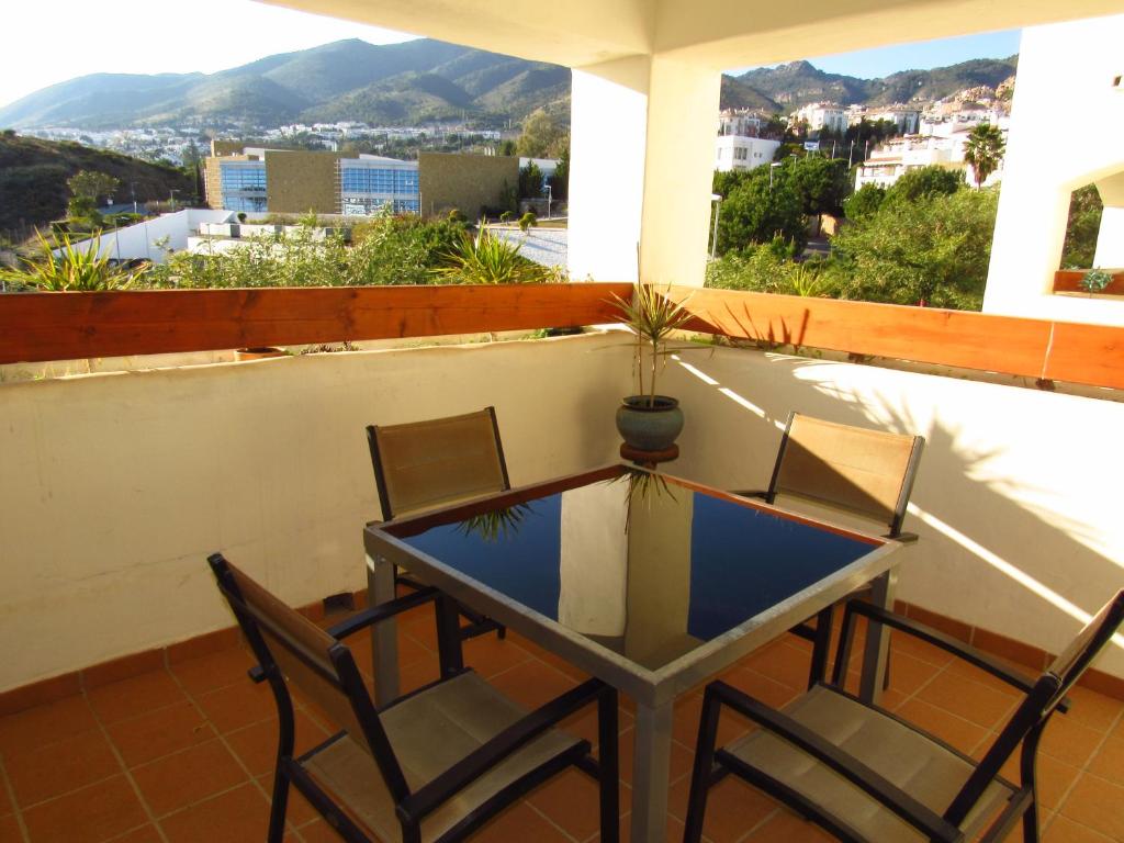 a table and chairs on a balcony with a view at Arenal Golf in Benalmádena