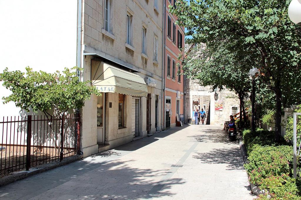 an empty street in a city with a building at Apartment Mimica-Croatia , Omis , Center in Omiš