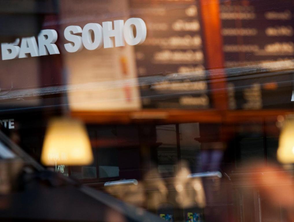 a blurry picture of a bar soo sign in a store at The Z Hotel Soho in London