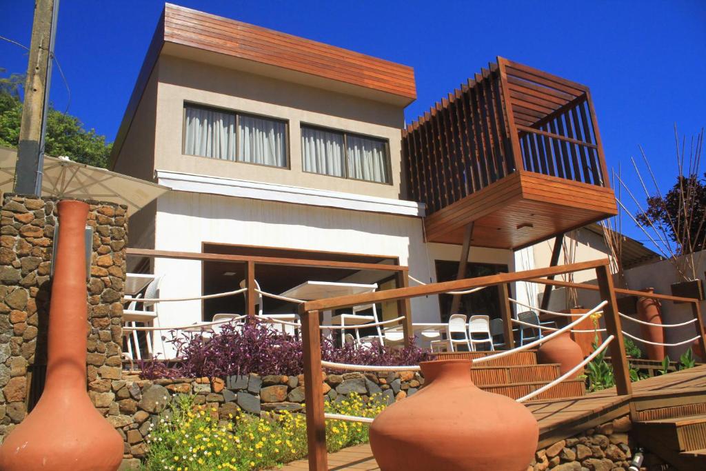 a house with large vases in front of it at Pousada Corveta in Fernando de Noronha