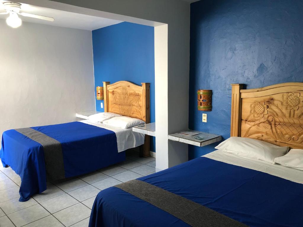 Postel nebo postele na pokoji v ubytování Hotel San Juan