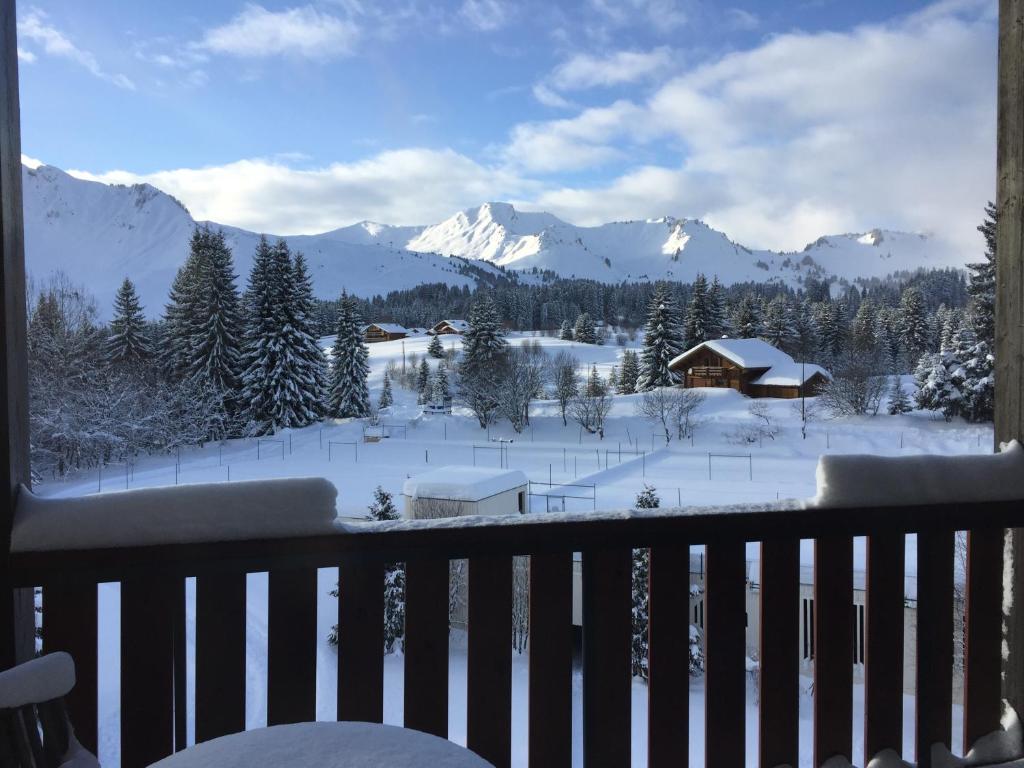 a balcony with a view of a snow covered mountain at Prazdelys in Le Praz de Lys