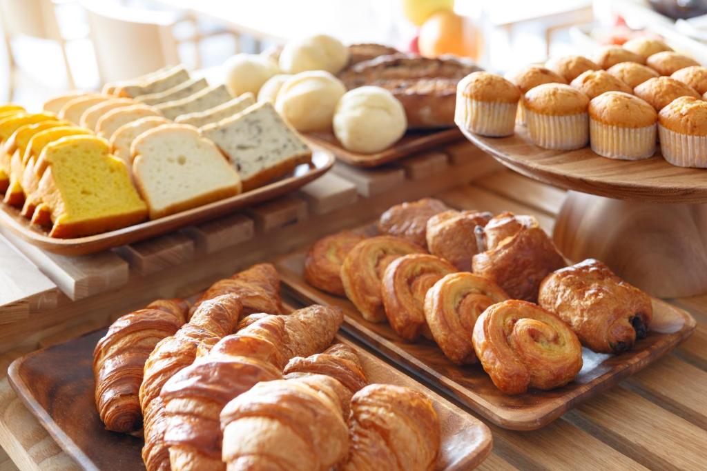 a display of different types of bread and pastries at Haneda Excel Hotel Tokyu Haneda Airport Terminal 2 in Tokyo