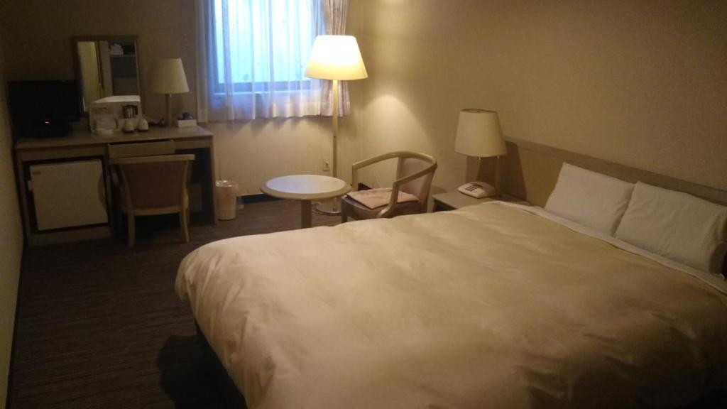 Postel nebo postele na pokoji v ubytování Hotel Hitachi Hills