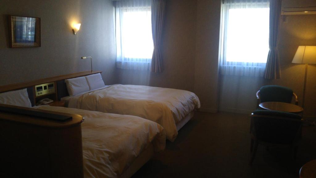 Postel nebo postele na pokoji v ubytování Hotel Hitachi Hills
