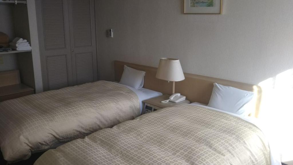 Postel nebo postele na pokoji v ubytování Hotel Hitachi Hills