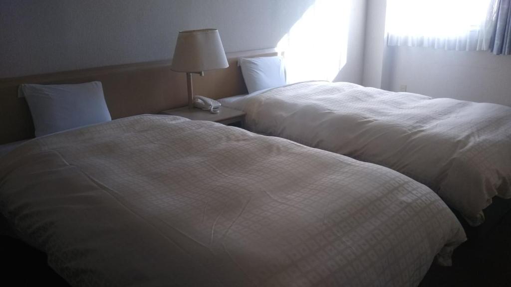 Postel nebo postele na pokoji v ubytování Hotel Hitachi Hills