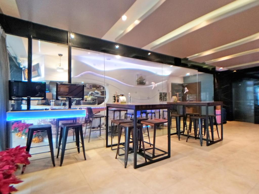 a bar in a room with stools and tables at Beauty Hotels Taipei - Hotel B6 in Taipei
