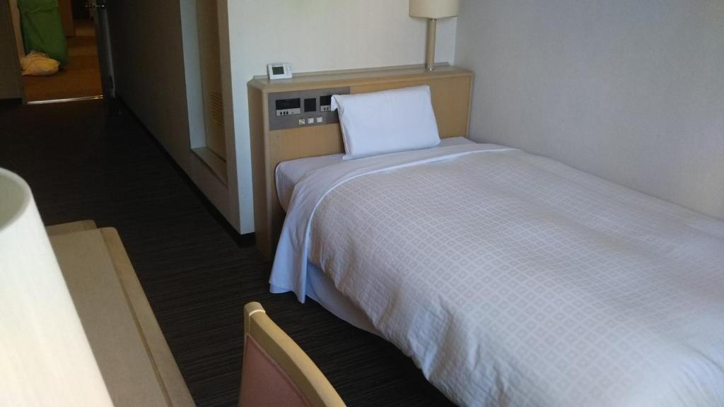 Postel nebo postele na pokoji v ubytování Hotel Hitachi Hills