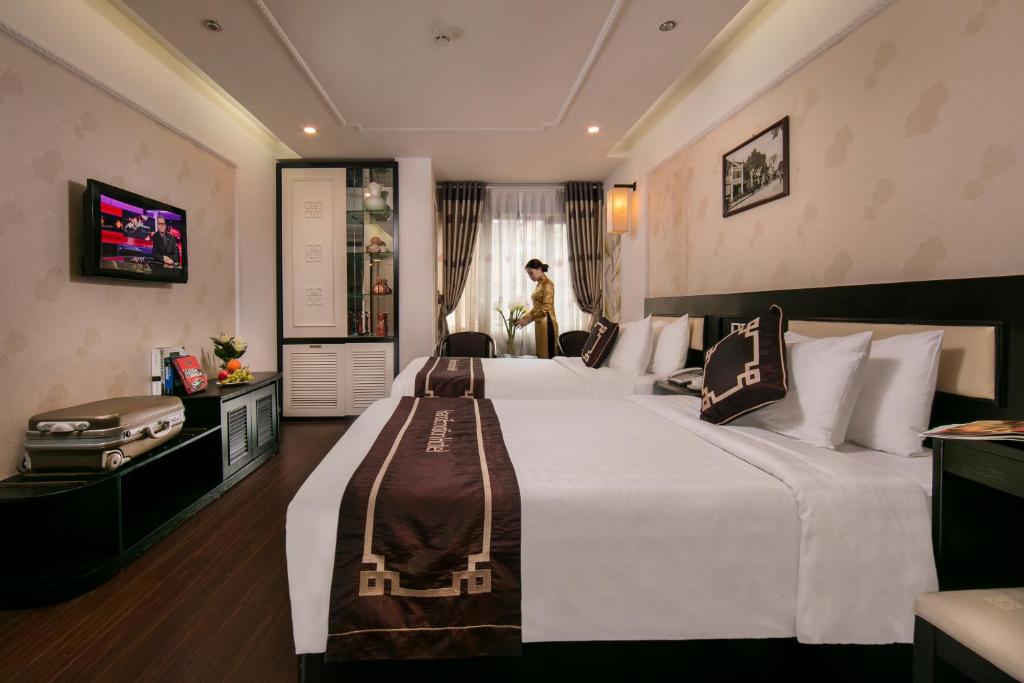 Postel nebo postele na pokoji v ubytování Hanoi Emotion Hotel