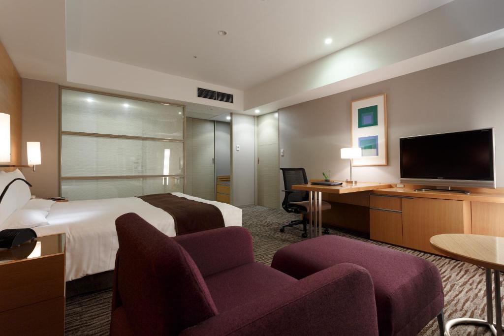 a hotel room with a bed and a flat screen tv at Haneda Excel Hotel Tokyu Haneda Airport Terminal 2 in Tokyo