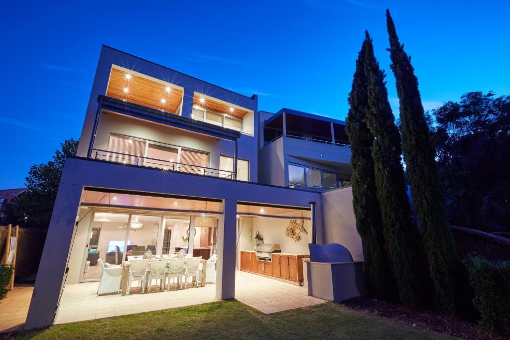 a house with large glass doors and a patio at The Bay Residence, Dunsborough WA in Quindalup