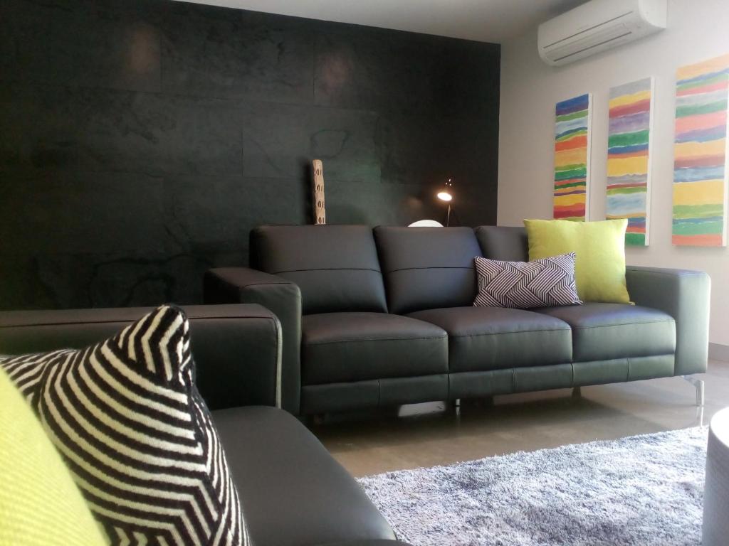a living room with a gray couch at East 34 in Ballarat