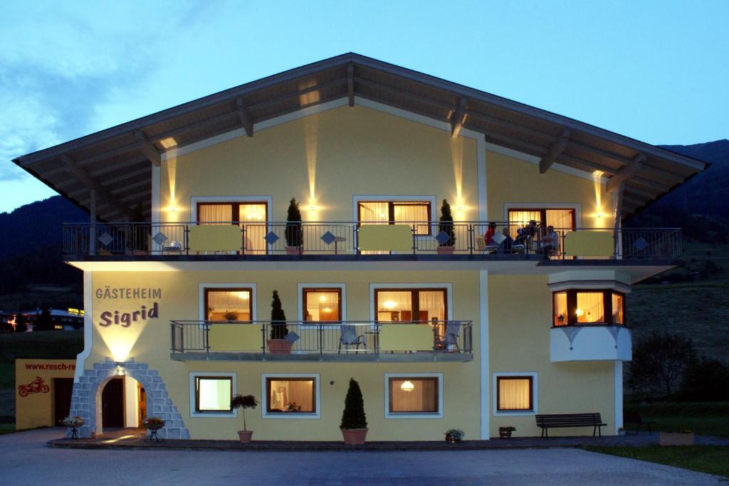 a large building with a balcony on top of it at Gästeheim Sigrid in Nauders