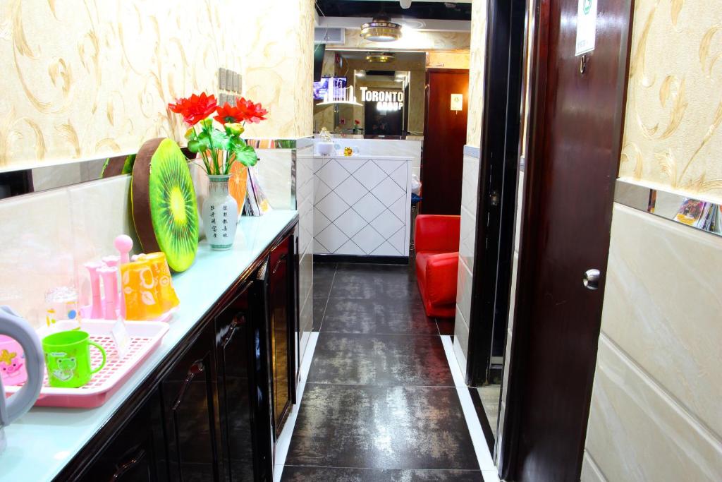 a kitchen with a counter top with flowers on it at Temple Street Hotel in Hong Kong