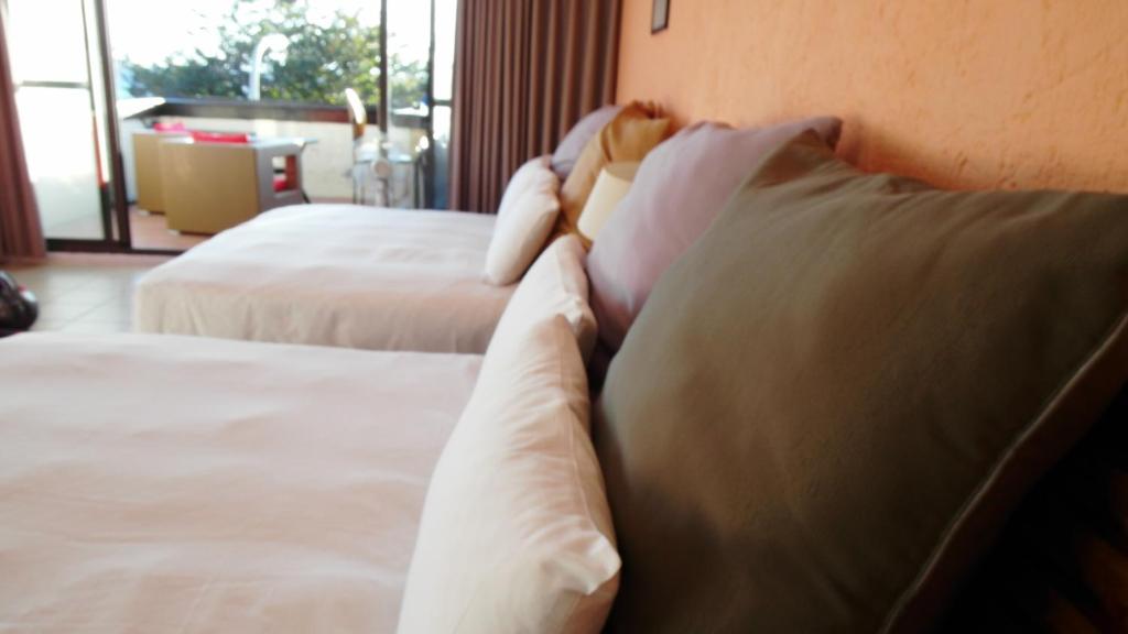 Postel nebo postele na pokoji v ubytování 小島旅店Island Inn