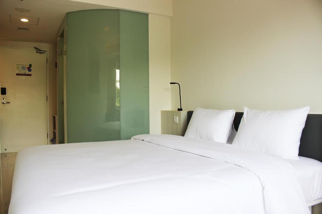 Postel nebo postele na pokoji v ubytování POP! Hotel Pemuda Semarang