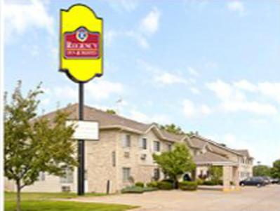 a yellow sign in front of a building at Regency Inn & Suites in Anoka