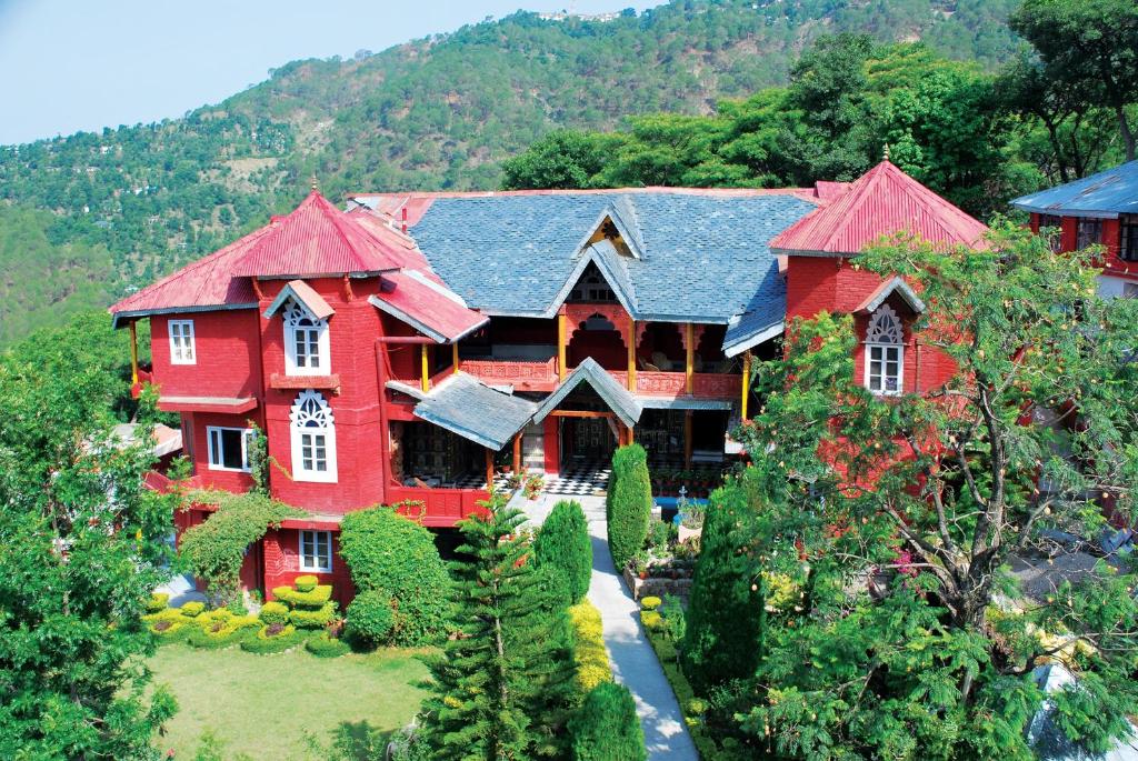 an aerial view of a large red house at WelcomHeritage Grace Hotel in Dharamshala
